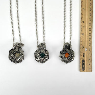 all bottle pendant necklace options ;aying flat with ruler for size reference