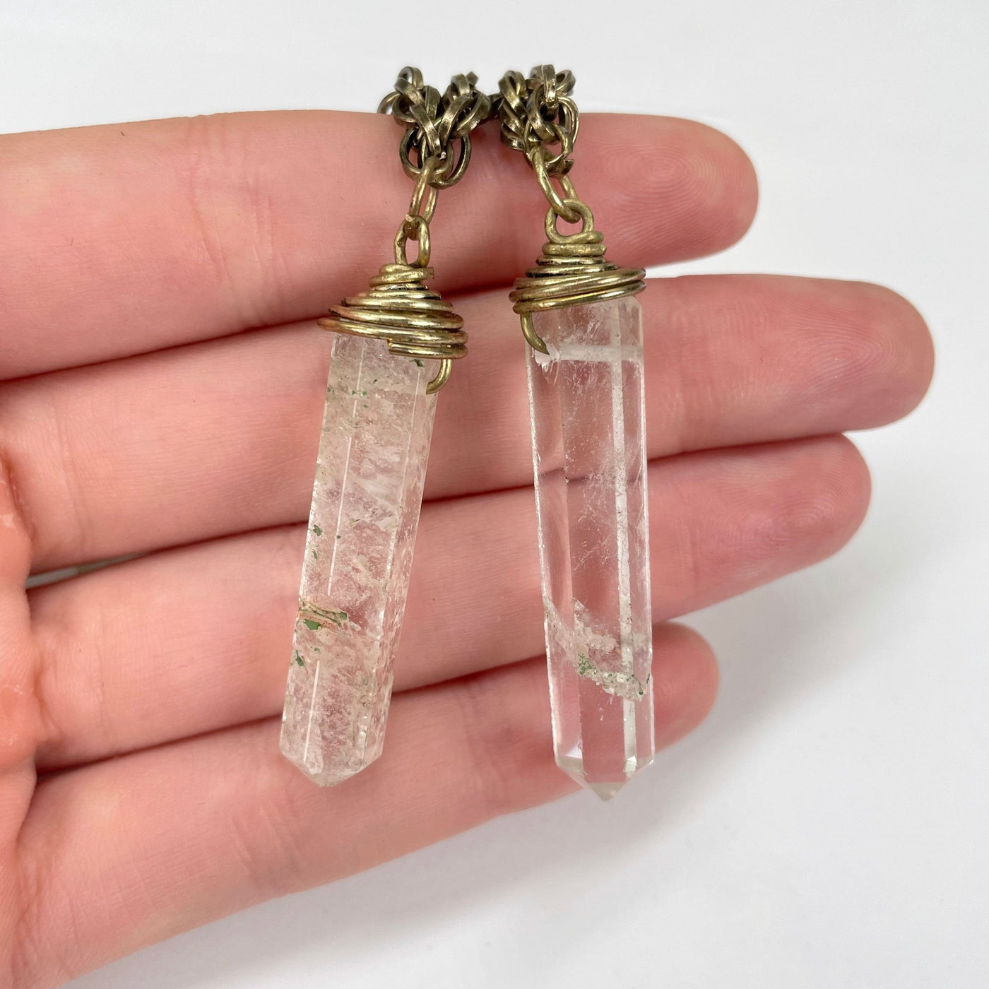 outer crystal quartz pendants in hand for size reference