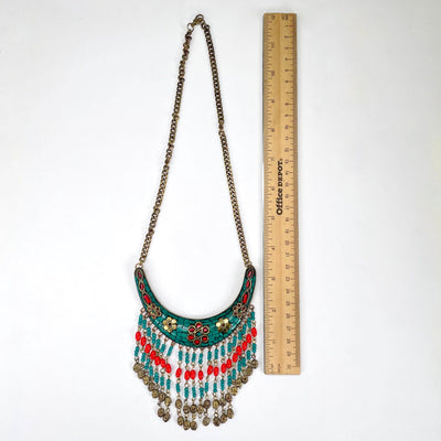 full length of tibetan style crescent pendant with beaded fringe with ruler for size reference