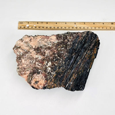 Black Tourmaline on Matrix with Mica next to a ruler for size reference