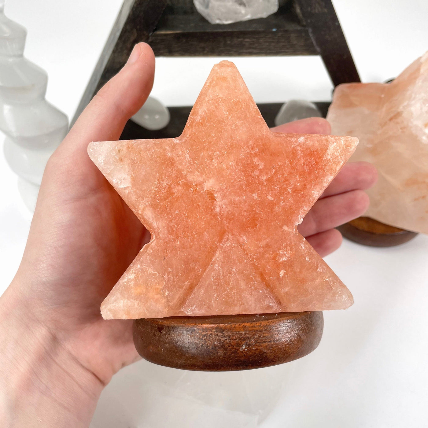 himalayan salt orange star lamp in hand for size reference