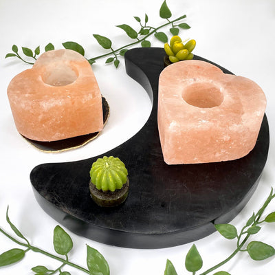angled view of two himalayan salt orange heart candle holders on display
