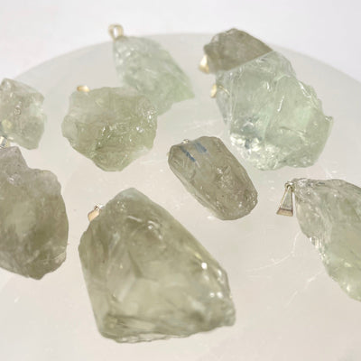 angled view of prasiolite rough pendants for thickness