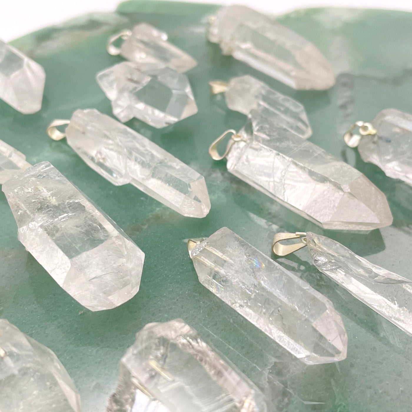 angled view of crystal quartz rough point pendants for thickness