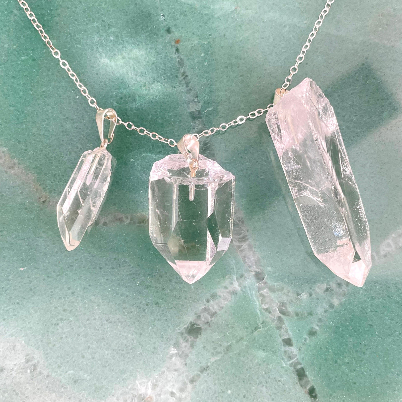 three crystal quartz rough point pendants on chain