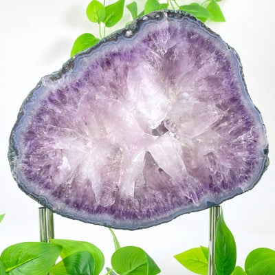 close up of large amethyst slab on stand for details