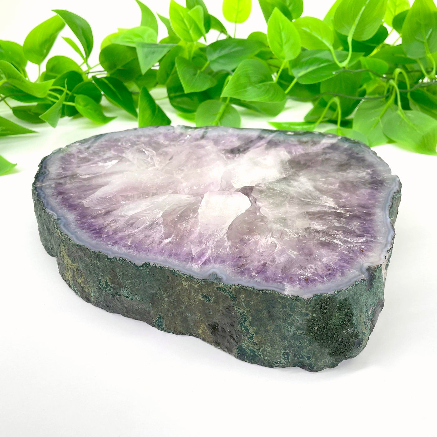angled view of large amethyst slab laying flat