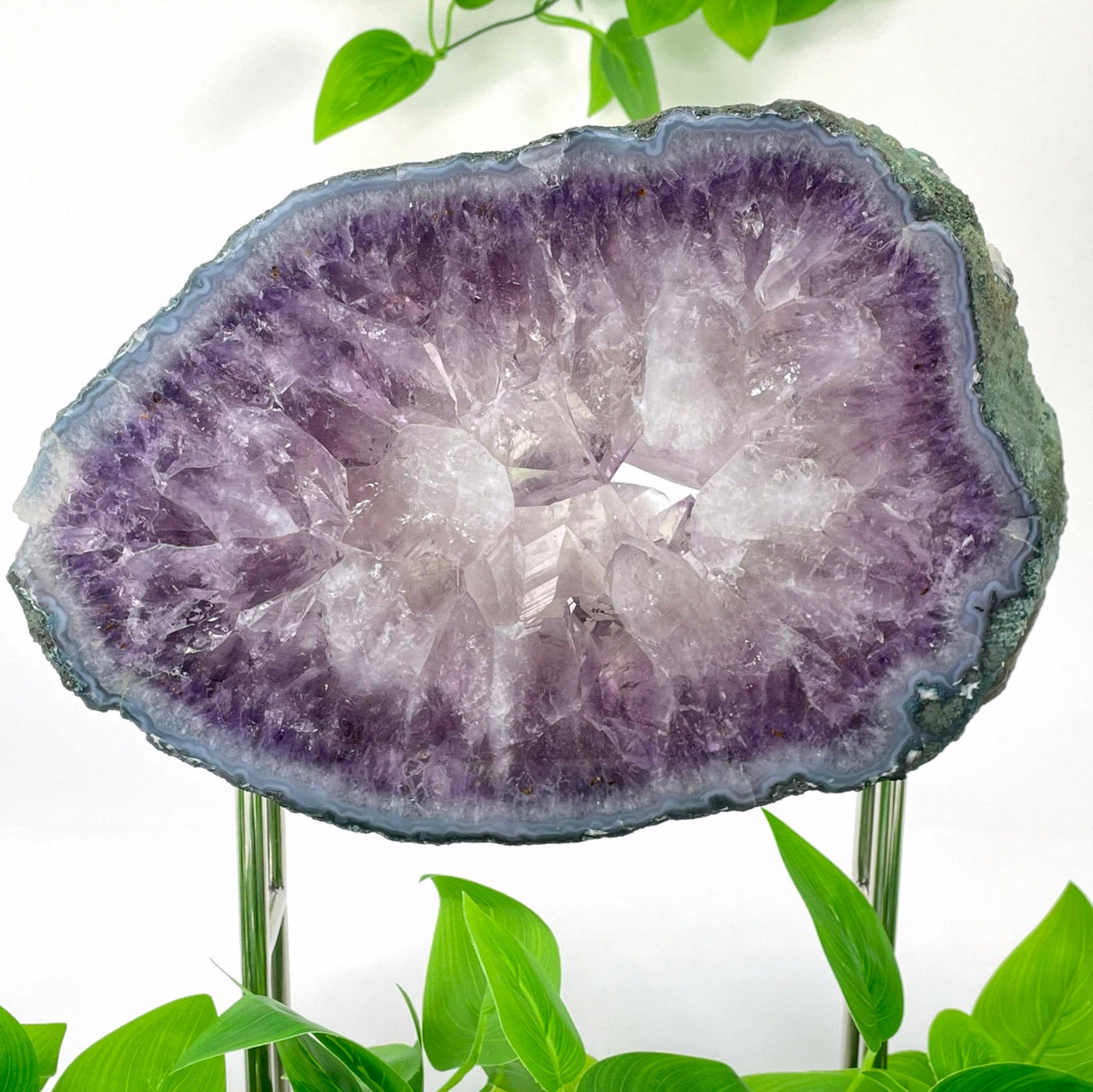 close up of large amethyst polished slab on stand for details