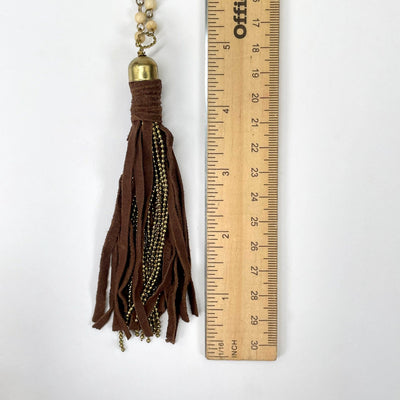 close up of tassel pendant with ruler for size reference