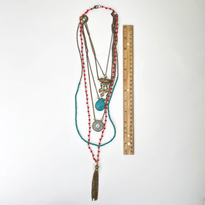 full necklace length laying flat on white background with ruler for size reference