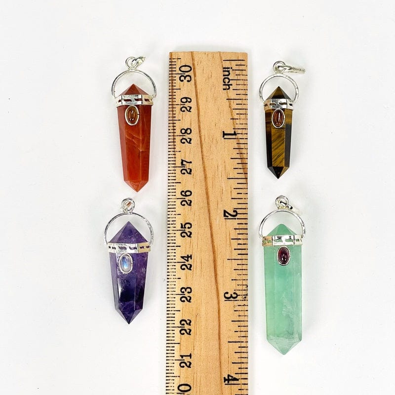 pendants next to a ruler to show the possible sizes 