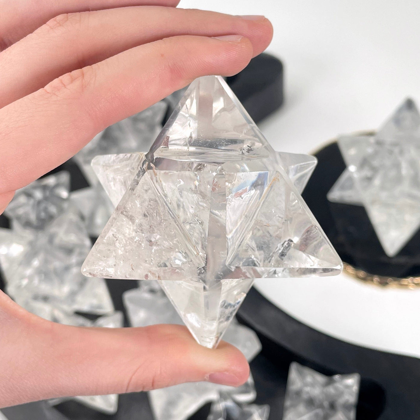 close up of one crystal quartz merkabah star in hand for details
