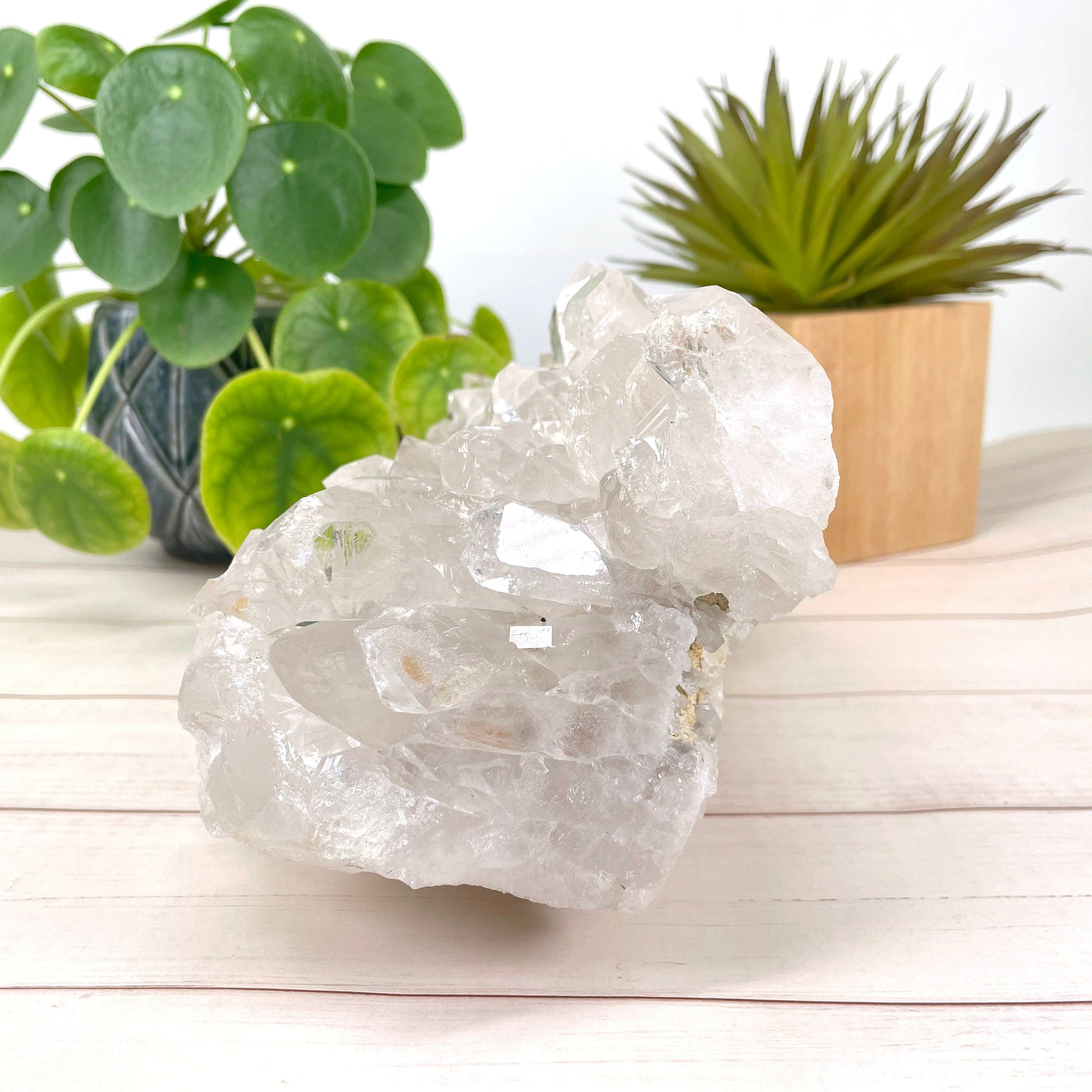 side view of crystal quartz cluster in front of backdrop for thickness