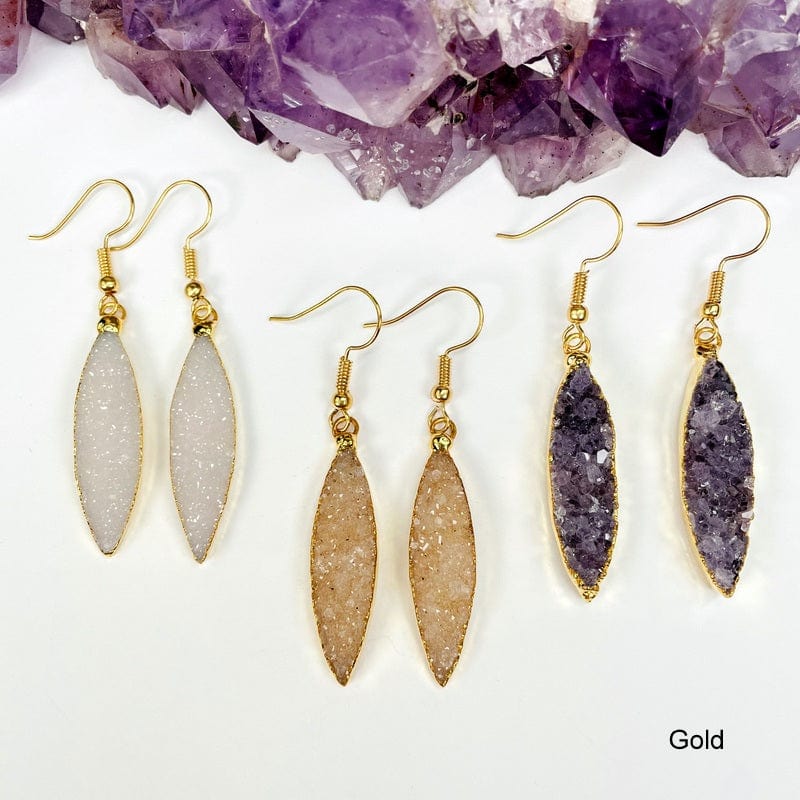 multiple gold earrings displayed to show the differences in the color shades