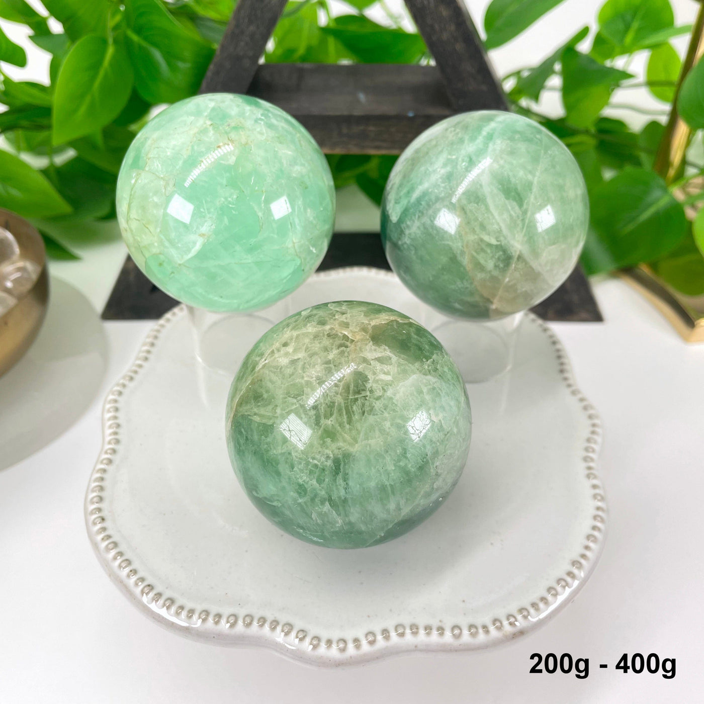 three 200g - 400g green fluorite spheres on display for possible variations
