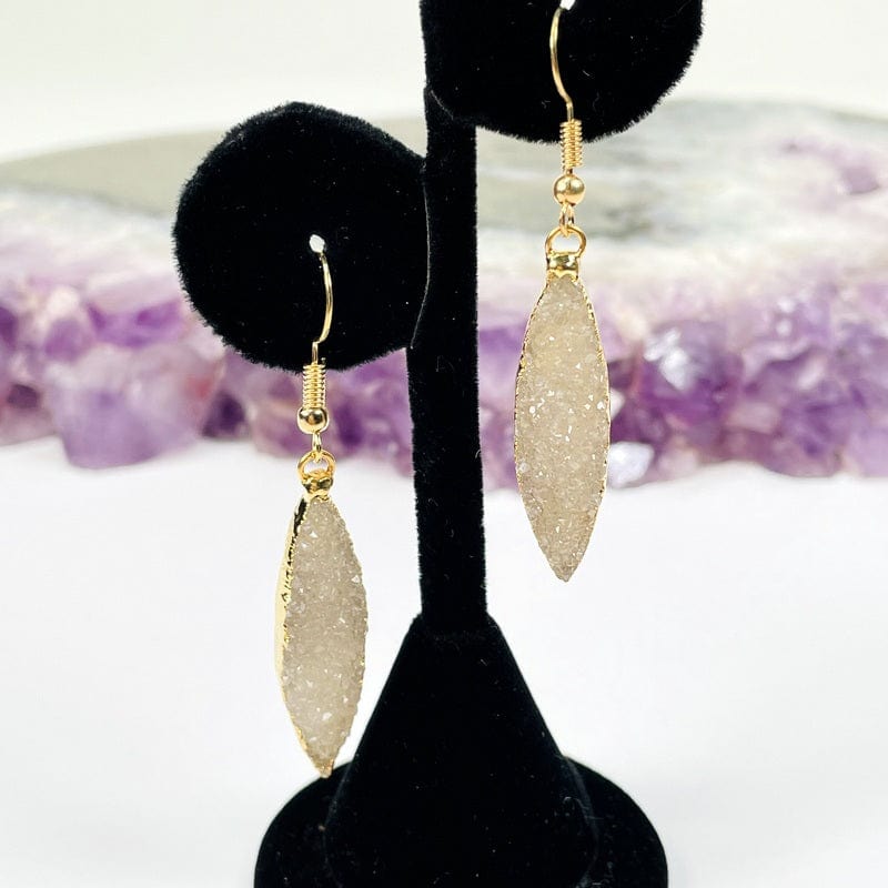 gold earrings displayed to show how they hang 