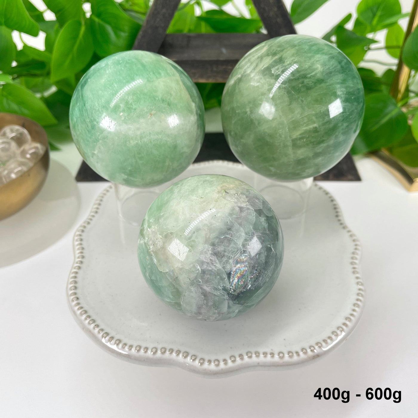 three 400g - 600g green fluorite spheres on display for possible variations