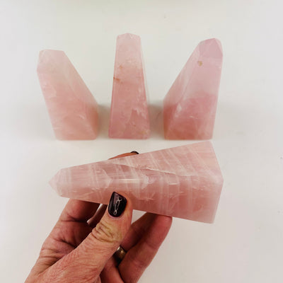 Rose Quartz Polished Obelisk Tower  Bulk Lot of 4 showing side view in a hand for size reference