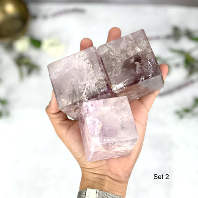 Hand holding up Set 2 of 3 pc Amethyst Cubes