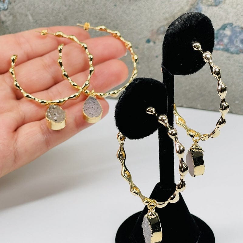 textured hoop earrings with a gold finish and a druzy drop accent