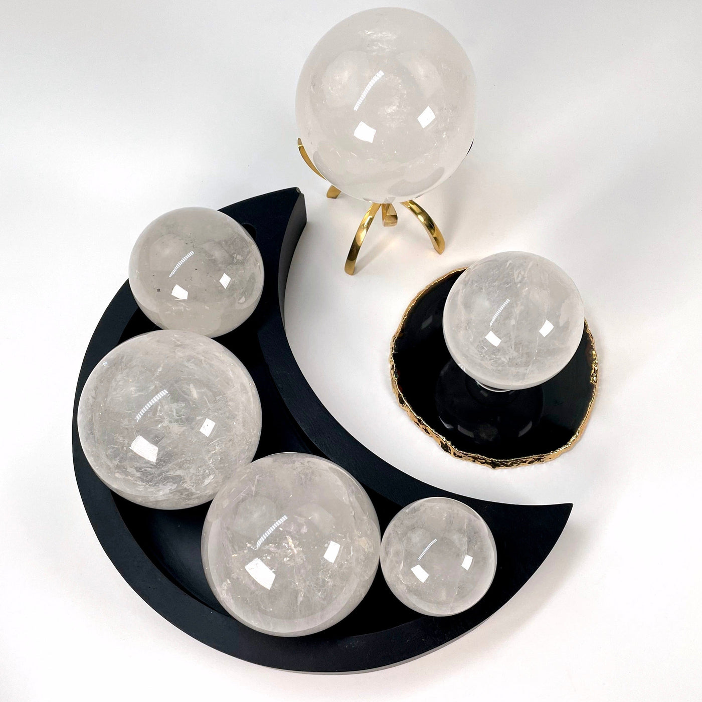 many different crystal quartz polished sphere weights on display for possible variations