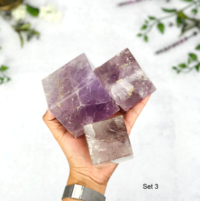 Hand holding up Set 3 of 3 pc Amethyst Cubes