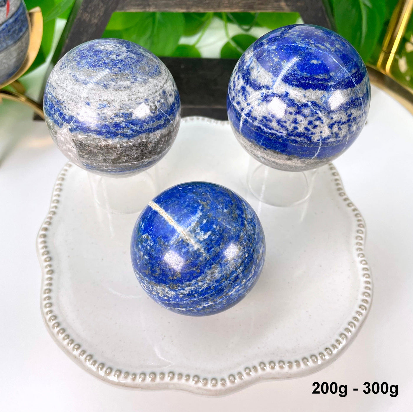 three 200g - 300g lapis lazuli polished spheres on display 