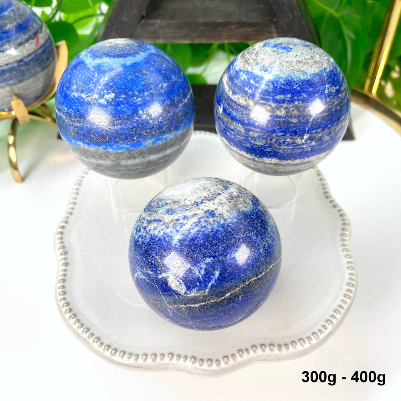 three 300g - 400g lapis lazuli polished spheres on display 