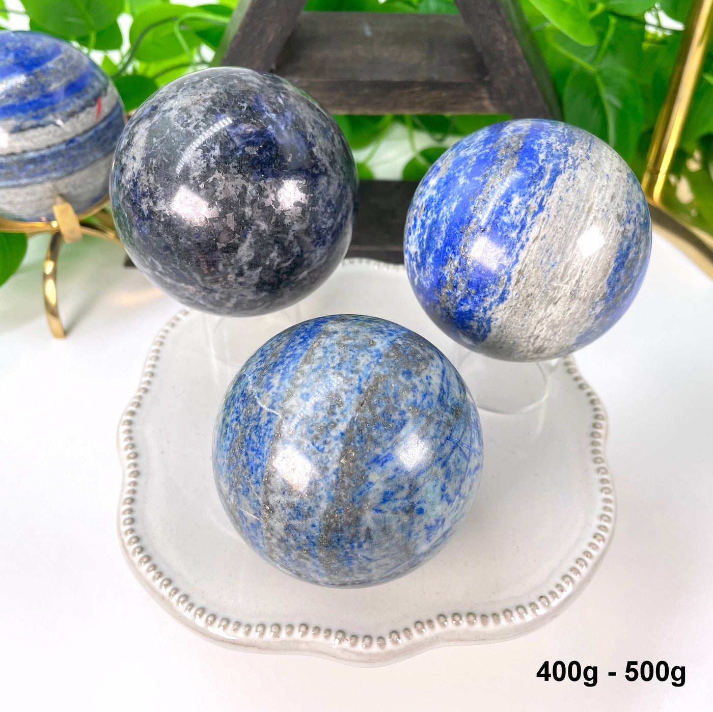 three 400g - 500g lapis lazuli polished spheres on display 