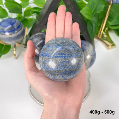 one 400g - 500g lapis lazuli polished sphere in hand 