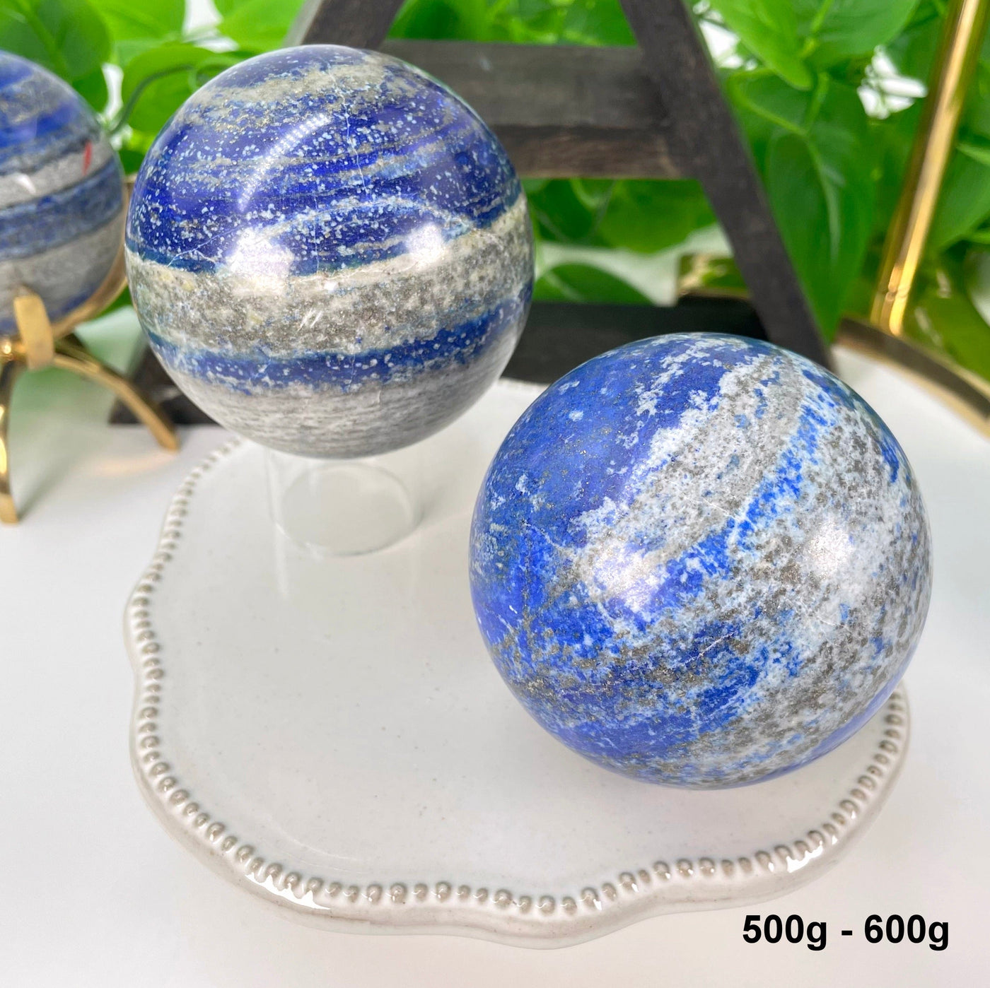 two 500g - 600g lapis lazuli polished spheres on display 