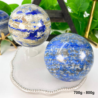 two 700g - 800g lapis lazuli polished spheres on display 