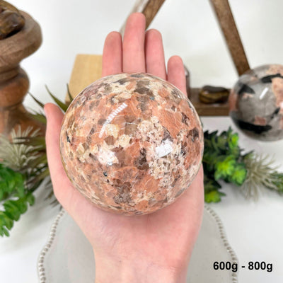 one 600g - 800g sphere in hand for size reference