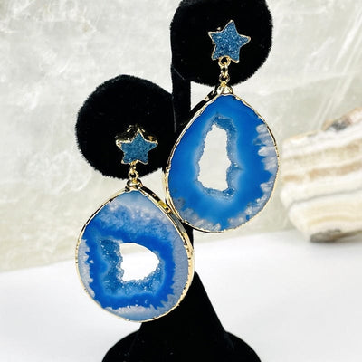 close up of the agate earrings with a star accent in blue