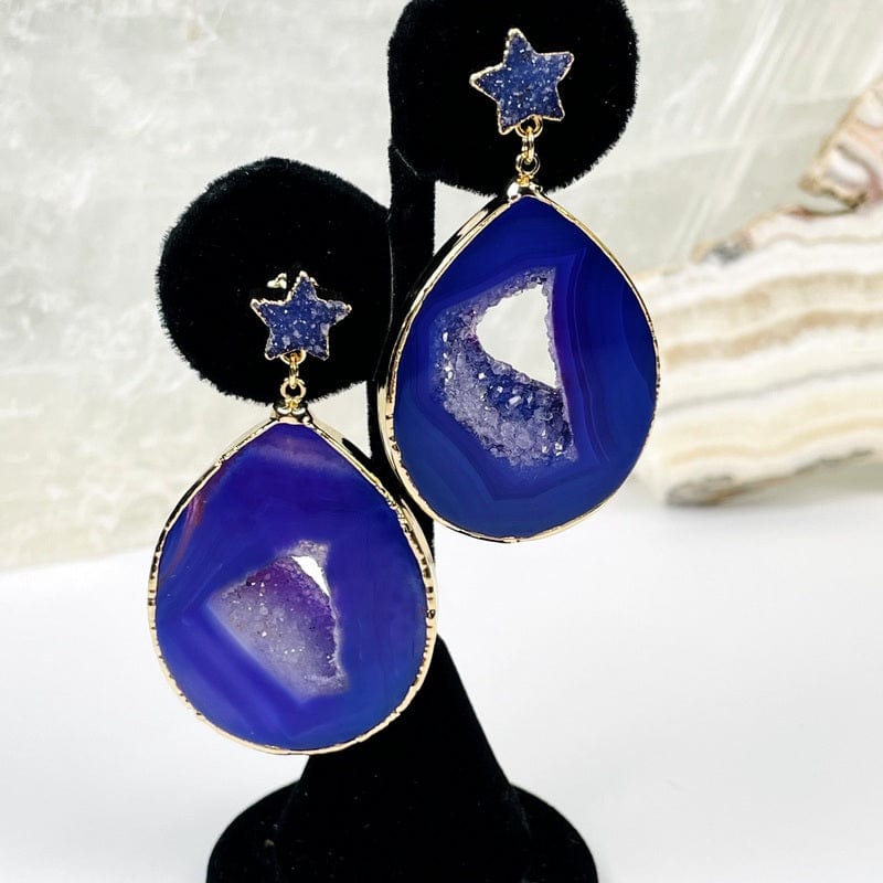 close up of the agate earrings with a star accent in purple 