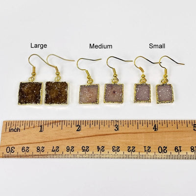 earrings next to a ruler for size reference. available in small medium and large 