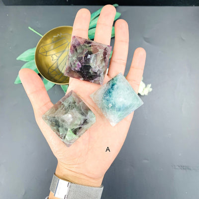 Hand holding up set A of Fluorite Pyramid