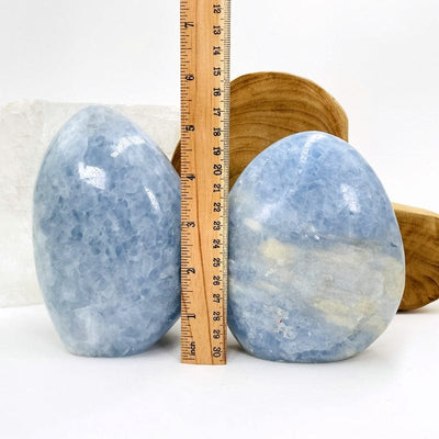 1 kilo sized blue calcite next to a ruler for size reference 