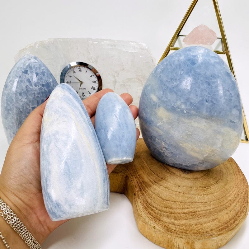 blue calcite cut bases in hand for size reference 