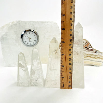 crystal quartz obelisk next to a ruler for size reference 