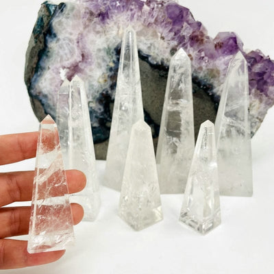 multiple crystal quartz obelisk displayed to show the differences int the sizes 