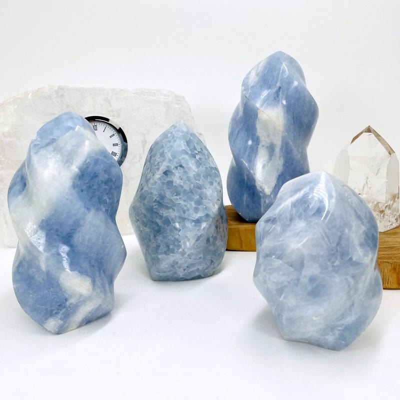 multiple blue calcite flame towers displayed to show the differences in the color shades and sizes 