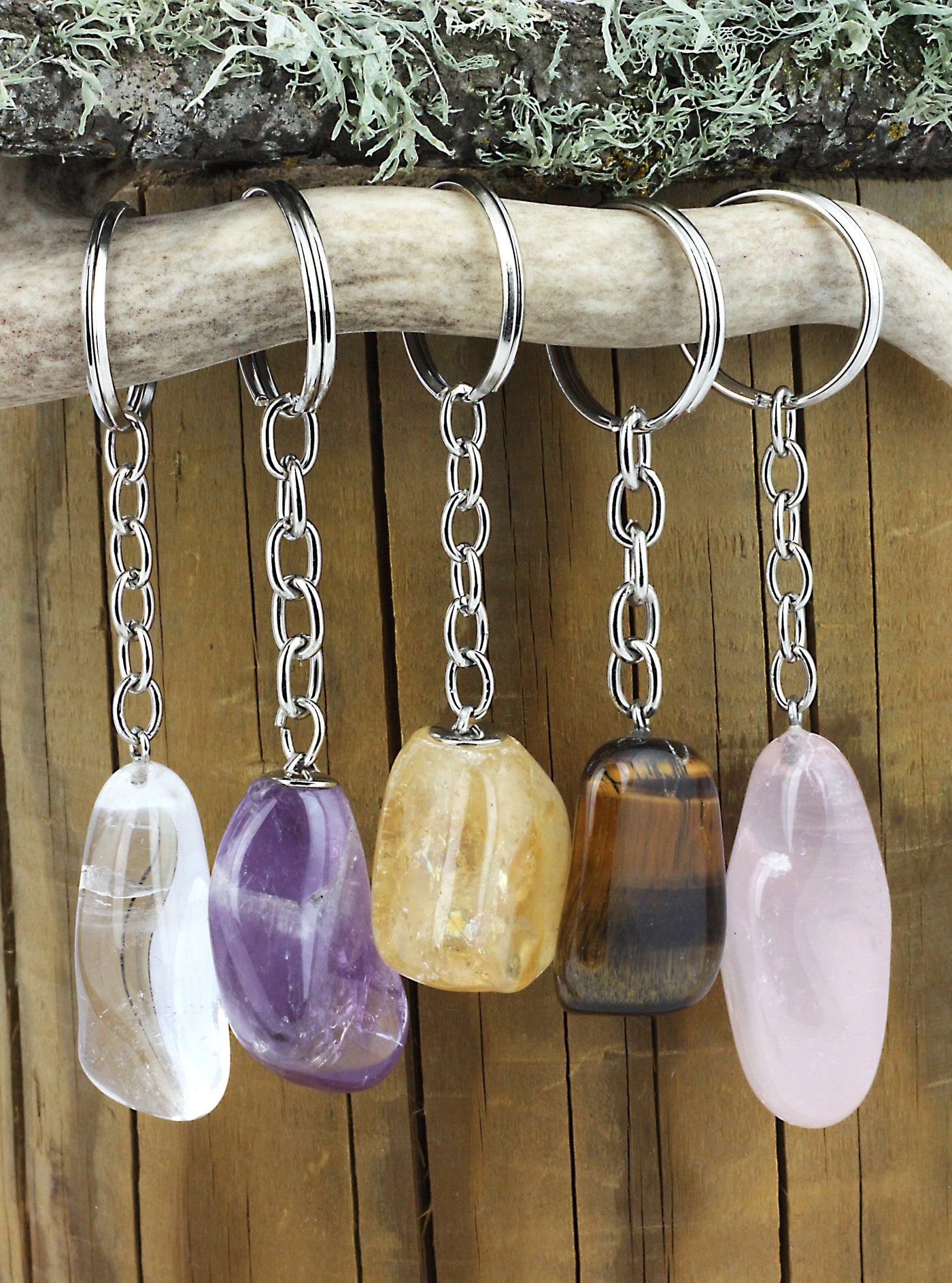 5 tumbled keychains hanging on a stick
