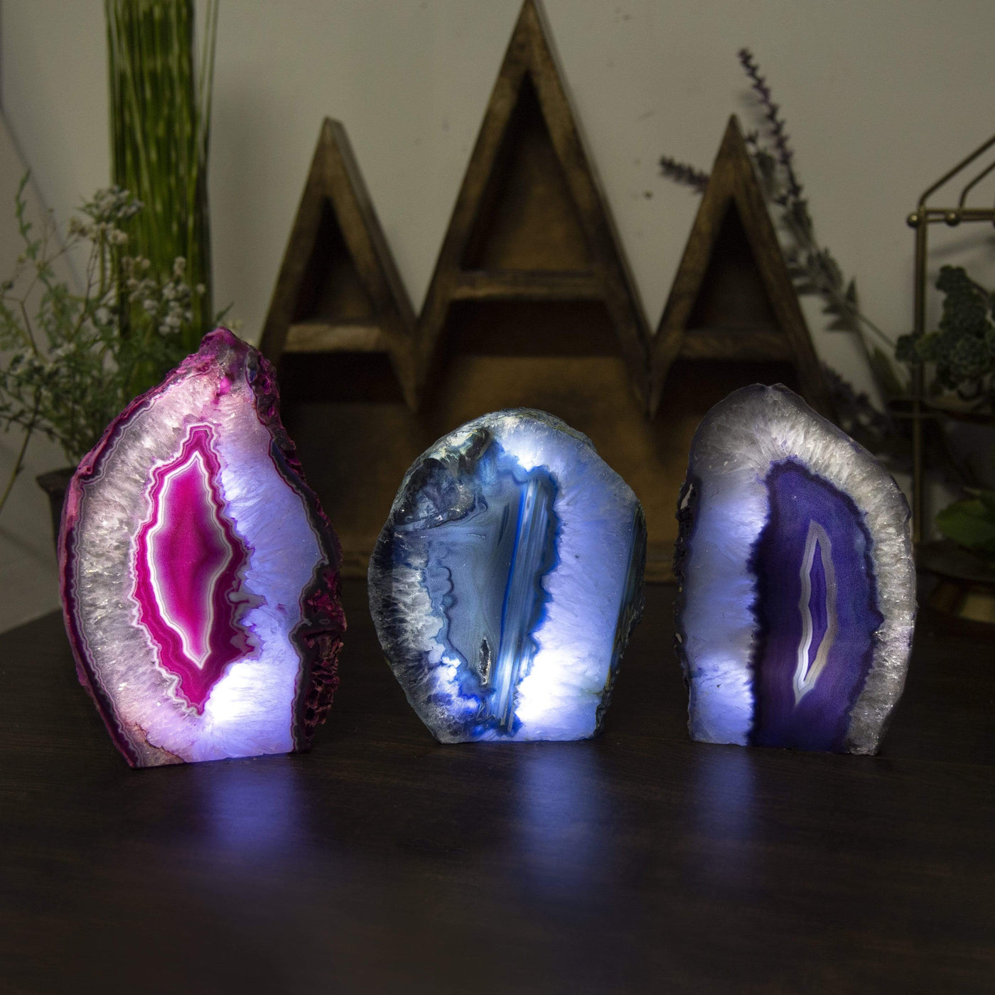 Three agate lamps on a table lit with a dark surrounding within an alter.