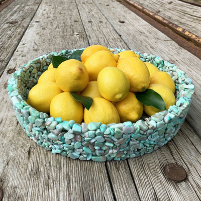 green tumbled bowl with lemons in it