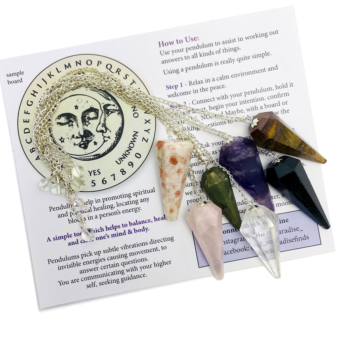 various colored crystal pendulums on information card
