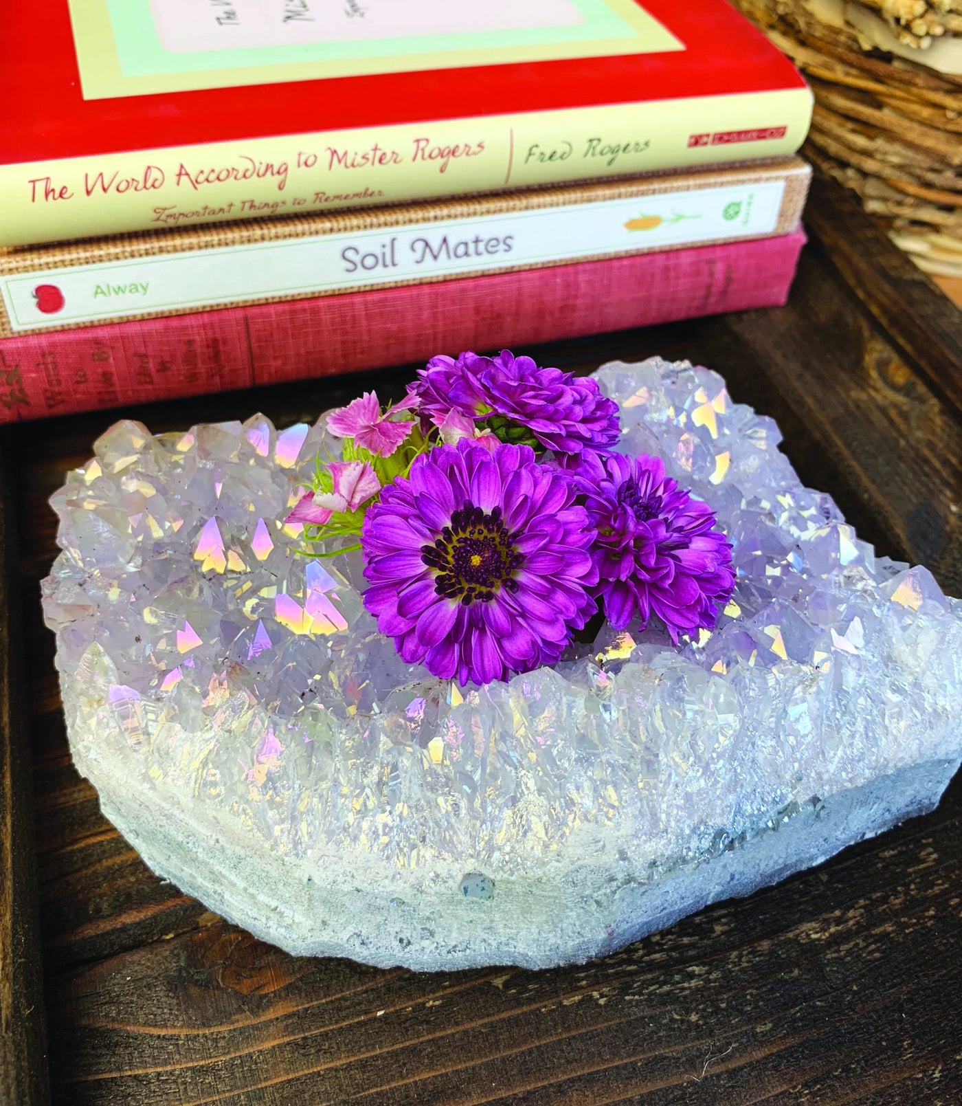 titanium amethyst candle holder with flowers inside and books in the background