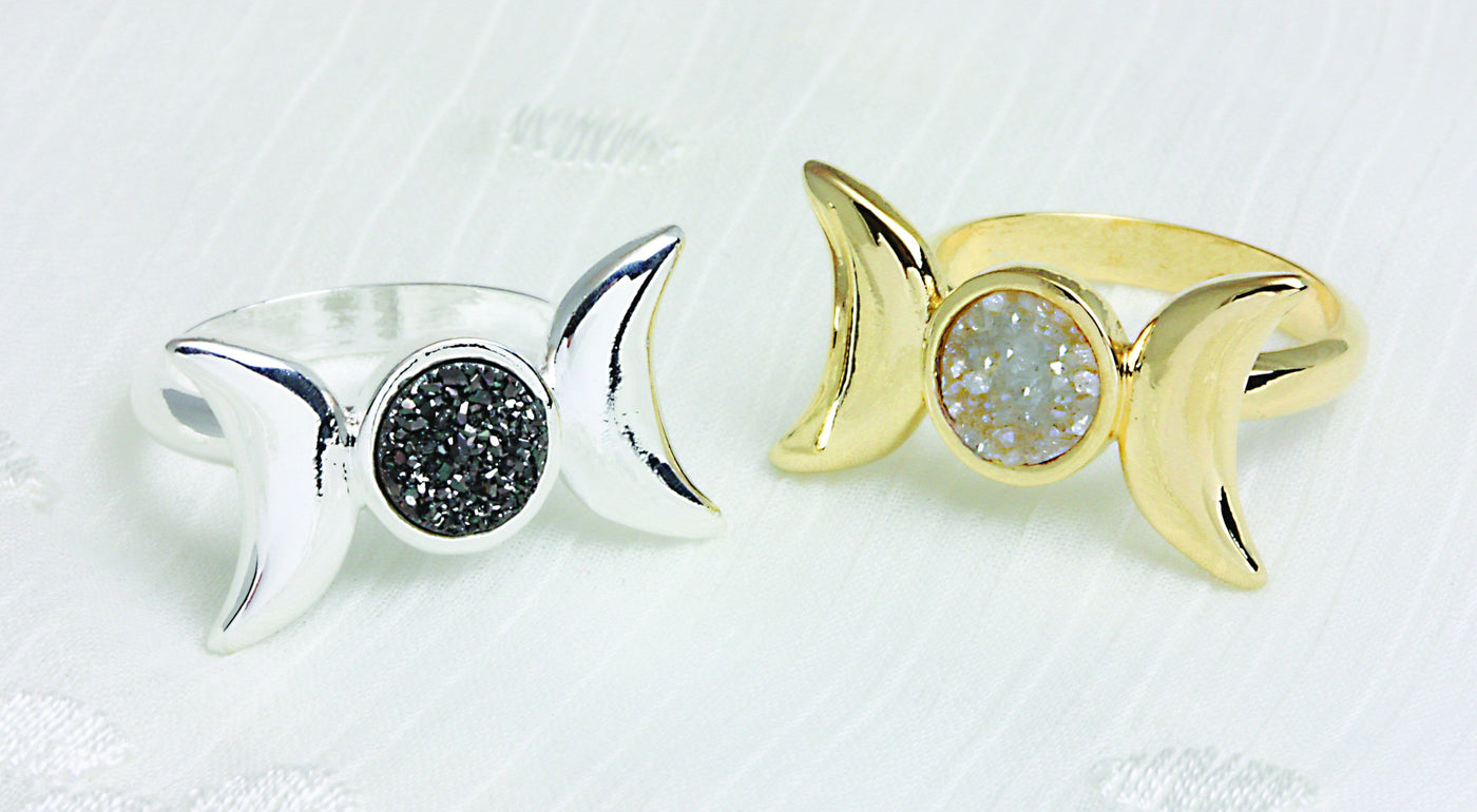 Moon Phase Rings both Gold and Silver Plated displayed. One of each.