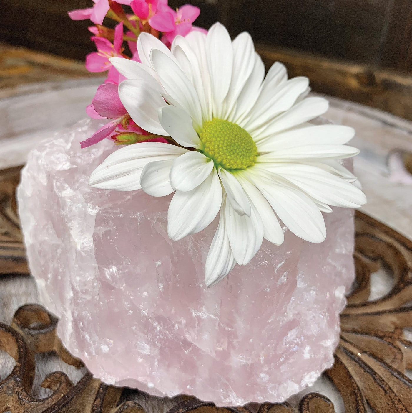 Up close shot of Rose Quartz Candle Holder with flowers in it