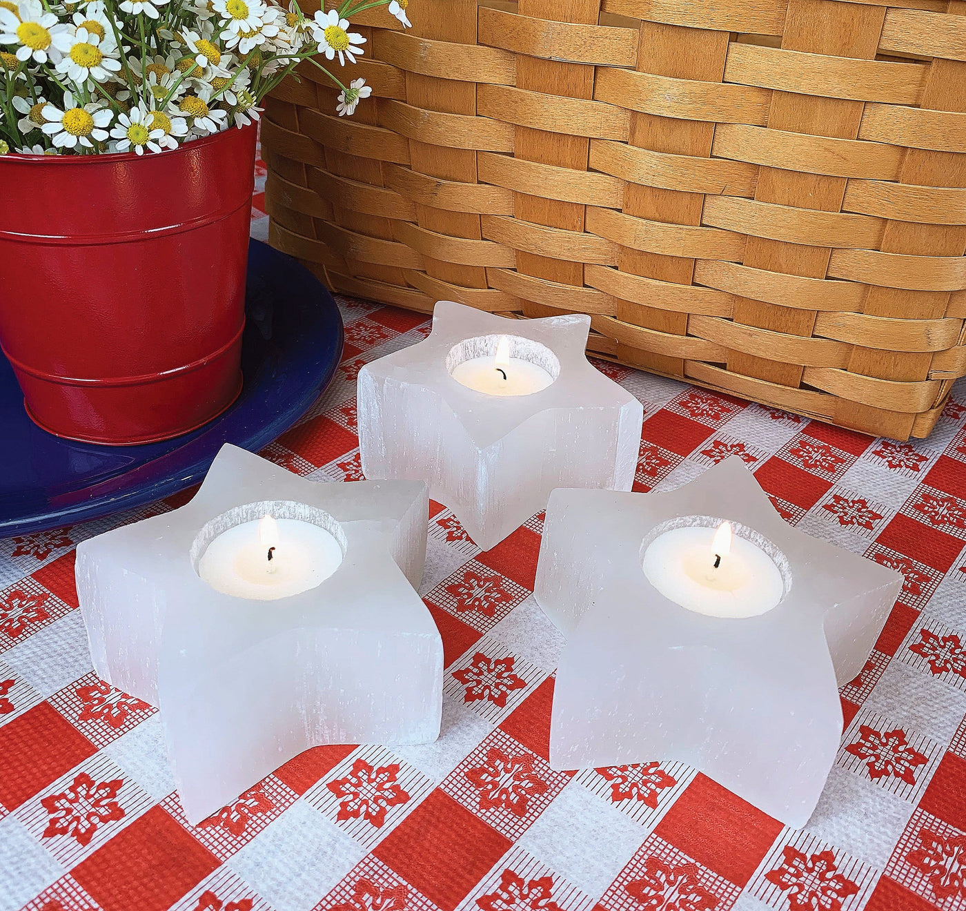 three selenite star candle holder on display with candles (not included with purchase) 